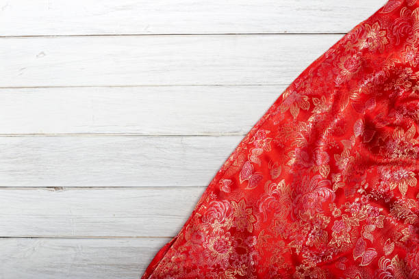 istock Red silk on old wooden table , Concept Chinese New Year 902953686