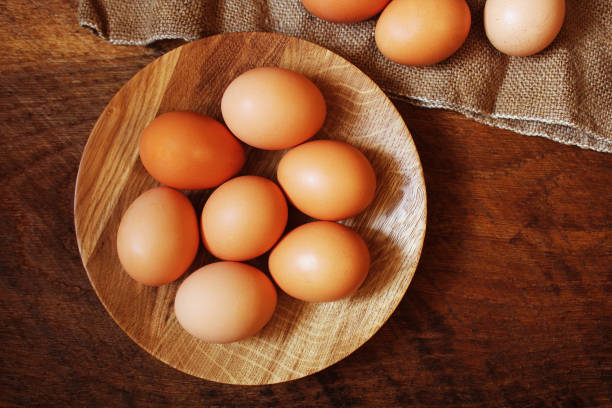 istock Easter background. Rustic wooden table with plate, egg, jute bag . Top view 902960800