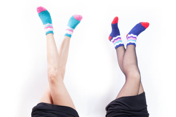 istock two girlfriends showing legs with winter socks 902965906