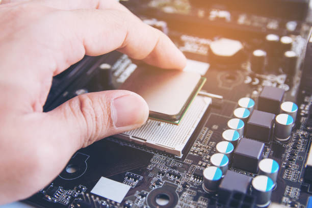 technician installing cpu chip microprocessor to socket on motherboard - technician computer part it support work tool imagens e fotografias de stock