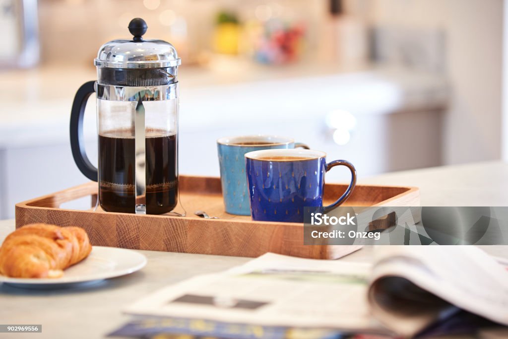 Coffee brewed in cafetiere on the kitchen work top Coffee brewed in cafetiere on the kitchen work top with woman in background using sink Coffee - Drink Stock Photo