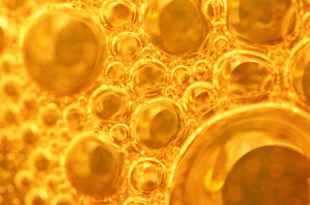 istock Golden background with big and small gold bubbles oil inside a gold liquid. 902973376