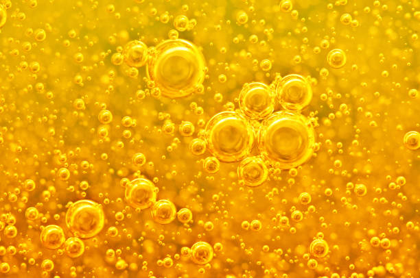 istock Golden background with big and small gold bubbles oil inside a gold liquid. 902974376