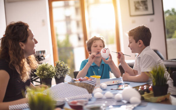 istock Family painting easter eggs 902974810