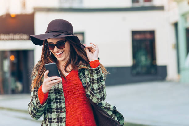 istock Happy girl with phone and hat 902974842