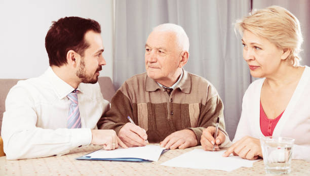 istock Couple signing agreement 902983246