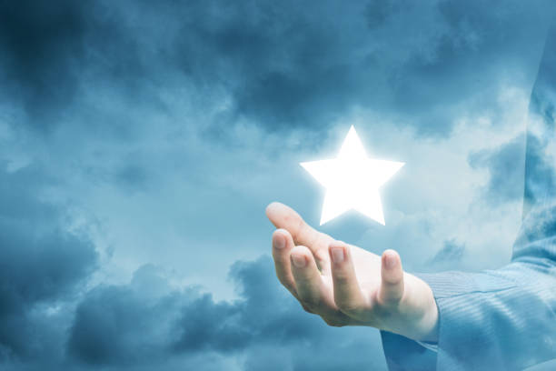 istock Hand of a businessman showing star. 902986738