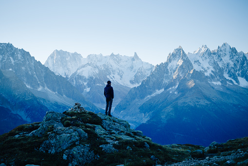 Man looking at the mountains near Chamonix, France. Old film style.