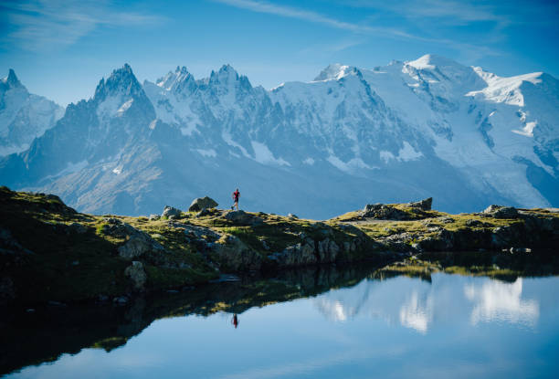 Mountain run Athlete trail running at Lac De Chéserys, with the Mont Blanc in the background. Old film style. aiguille de midi photos stock pictures, royalty-free photos & images