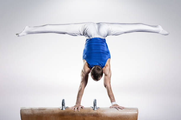 portrait of young man gymnasts portrait of young man gymnasts competing in the stadium artistic gymnastics stock pictures, royalty-free photos & images