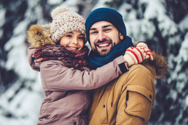 istock Dad with daughter outdoor in winter 902990636