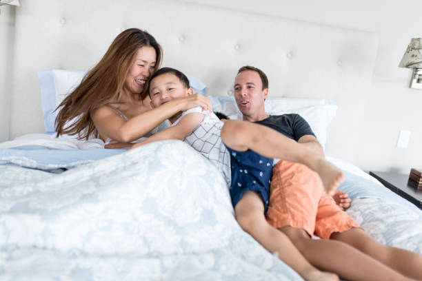 istock Family cuddling in bed 902990722