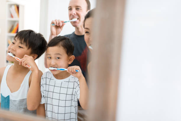 istock Family brushing their teeth in the bathroom 902990754
