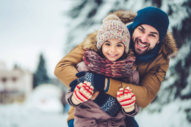 istock Dad with daughter outdoor in winter 902990784