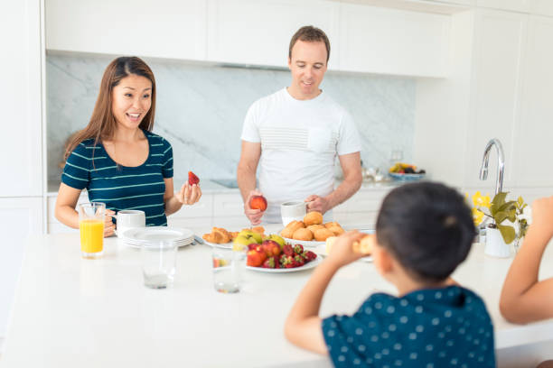 istock Family eating breakfast in the kitchen 902990788