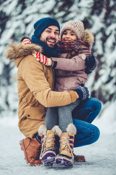 istock Dad with daughter outdoor in winter 902990864