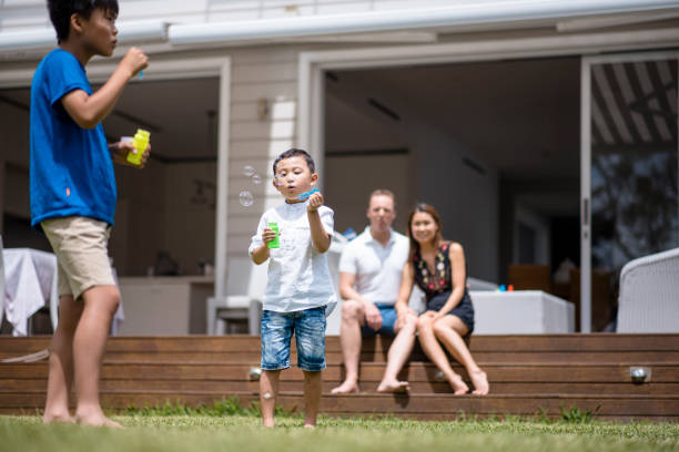 istock Two children blowing bubbles outdoors 902990908