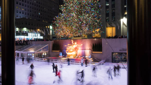 The Rink at Rockefeller Center People skating on the Rink with the Christmas tree as background at Rockefeller Center in New York on the december evening rockefeller ice rink stock pictures, royalty-free photos & images