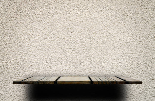 istock Wooden display shelf on Rough gray cement wall 902999214