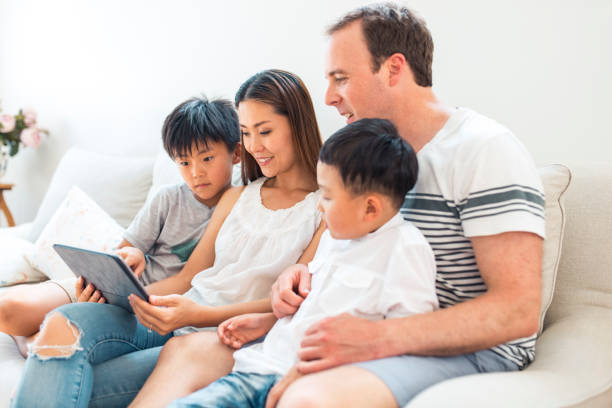 istock Family using digital tablet in living room 903002922