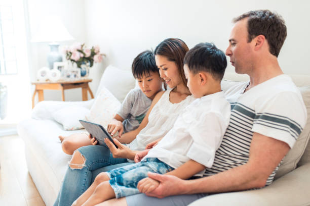 istock Family using digital tablet in living room 903002938