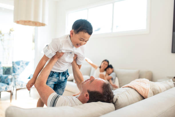 istock Father and son playing indoors 903002942