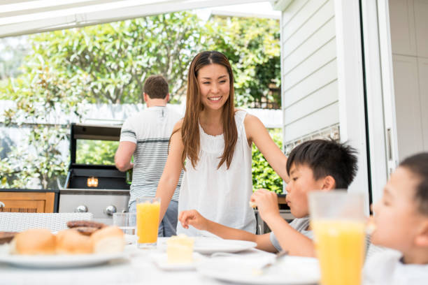 istock Family enjoying a barbecue outdoors in springtime 903003112