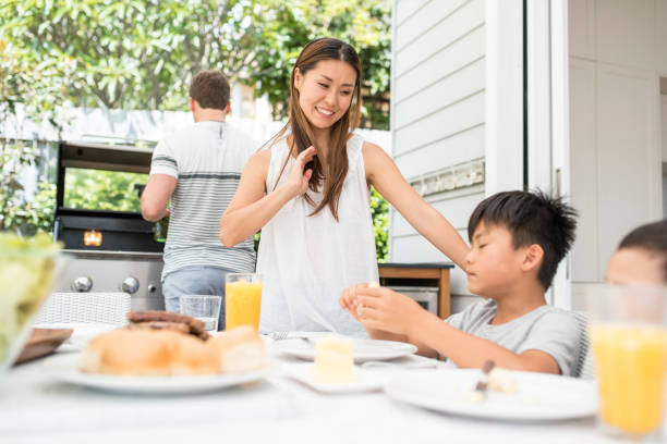 istock Family enjoying a barbecue outdoors in springtime 903003122
