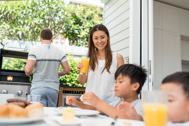istock Family enjoying a barbecue outdoors in springtime 903003376