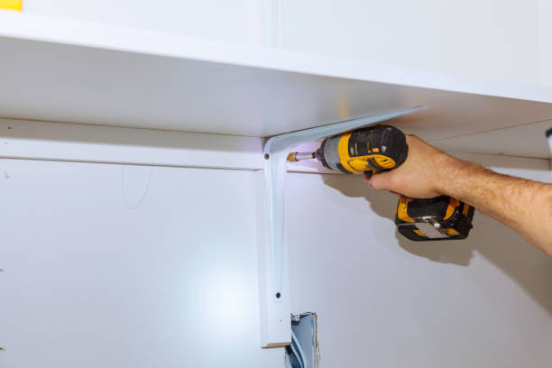 istock Man installing wooden shelves on brackets wall installing a shelf 903012612