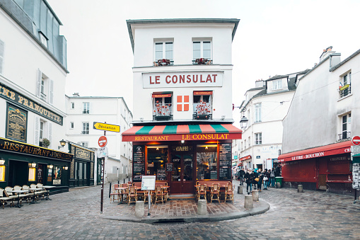 Montfort-l'Amaury, France, August 4, 2023; Cozy small square with terraces and restaurants in the center of the picturesque village Montfort-l'Amaury.