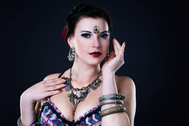 istock Women performs belly dance in ethnic dress on black background 903025550