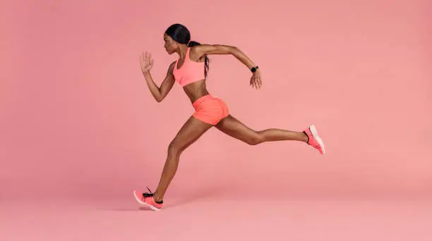 Photo of African female runner sprinting