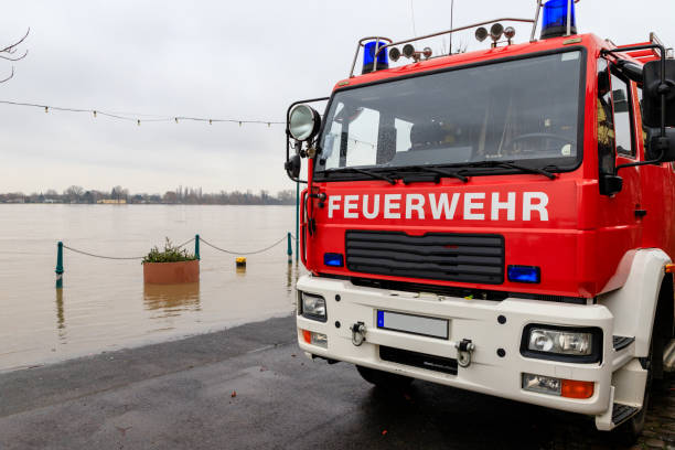Fire department car on the flooded shore of a river Fire department car on the flooded shore of a river. nierstein stock pictures, royalty-free photos & images