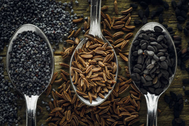 istock Poppy, cumin and black sesame seeds in a spoons 903036614