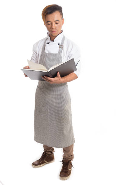 istock Male cook is reading about recipes. 903036836