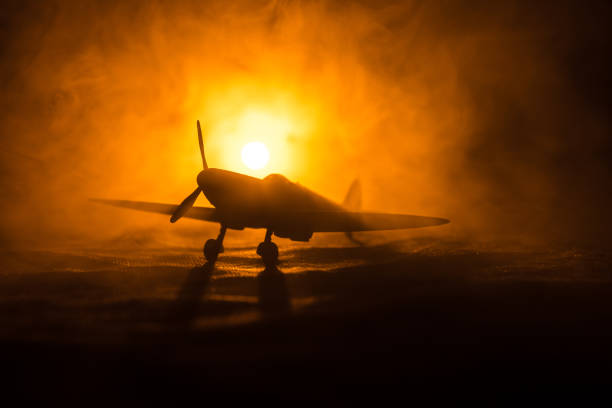 istock British jet-propelled model plane in possession. Dark orange fire background. War scene. 903037482