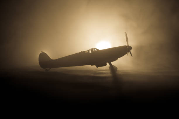 istock British jet-propelled model plane in possession. Dark orange fire background. War scene. 903037498