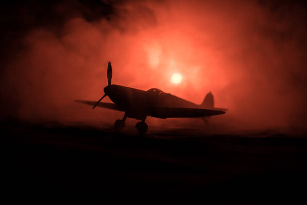 istock British jet-propelled model plane in possession. Dark orange fire background. War scene. 903037506