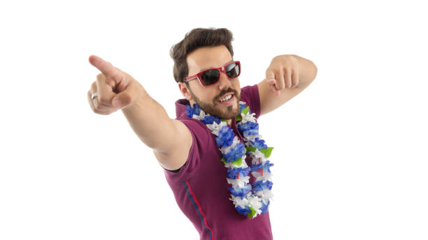 istock Carnival. Crazy man makes pose pointing with his fingers. Beautiful and bearded person. He is wearing a magenta polo shirt, flower necklace, and sunglasses.