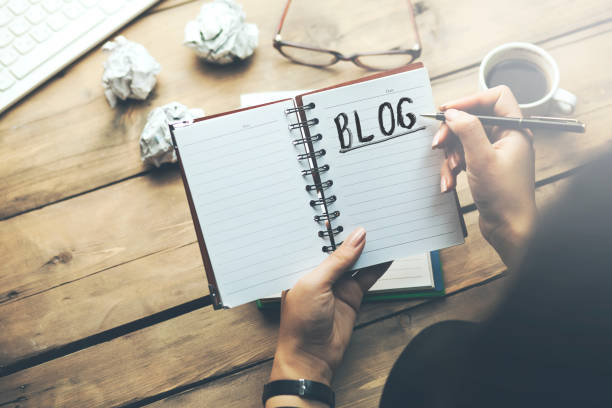istock woman writting blog text on notepad 903041340