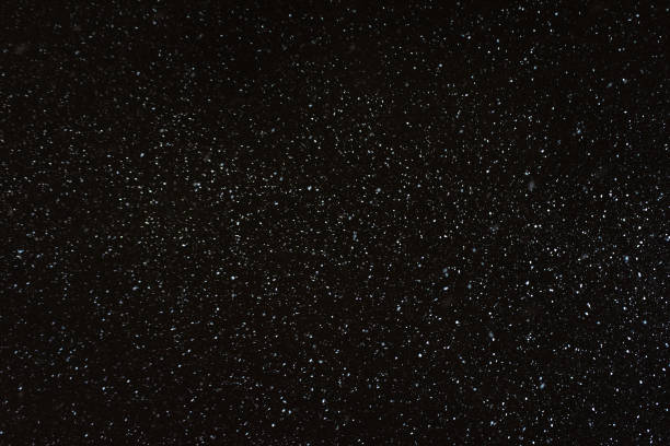 Abstract winter night background - snowflakes on a dark sky