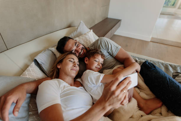 istock Loving family taking selfie on bed 903049256