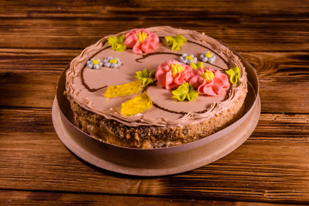 Kiev cake with cream on wooden table