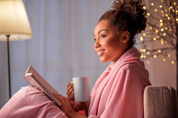 istock Peaceful young woman drinking hot beverage in apartment 903063048
