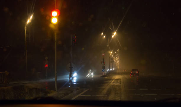 istock View through car windshield to night road with moving cars. 903065508