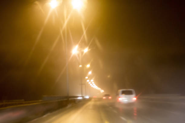 istock View through car windshield to night road with moving cars. 903065920