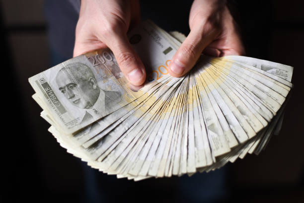 istock Hands holding pile of money 903068826