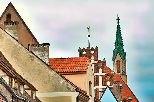 Red roofs of old houses in Skarnu iela street with St Johns church in the background Riga, Latvia