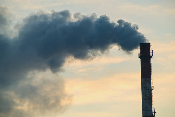 istock Pipe with smoke on a background of the sky close-up, with copy space. 903072810